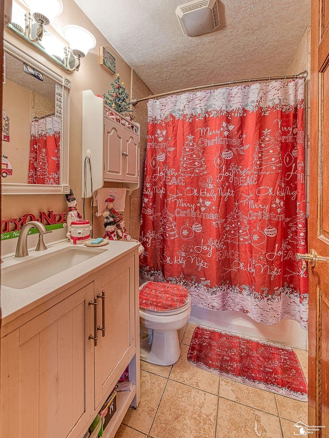 bathroom featuring tile patterned floors, a textured ceiling, toilet, vanity, and a shower with shower curtain