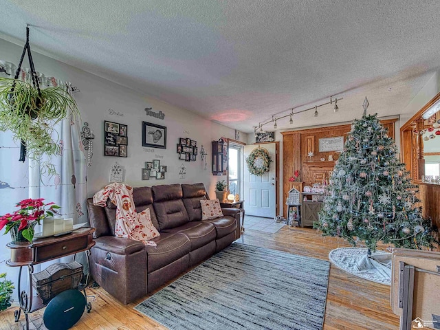 living room featuring a textured ceiling and light wood-type flooring