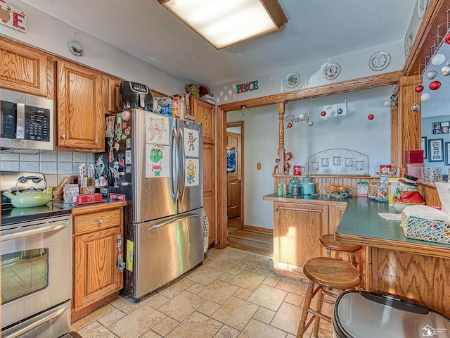 kitchen with backsplash and stainless steel appliances