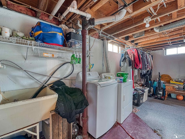 clothes washing area with independent washer and dryer and a wealth of natural light