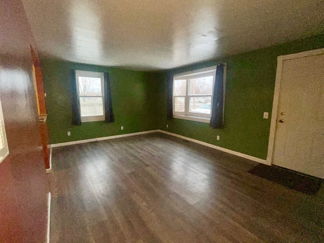 unfurnished room featuring dark hardwood / wood-style floors