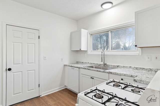 kitchen featuring dark hardwood / wood-style flooring, white cabinetry, sink, and white appliances