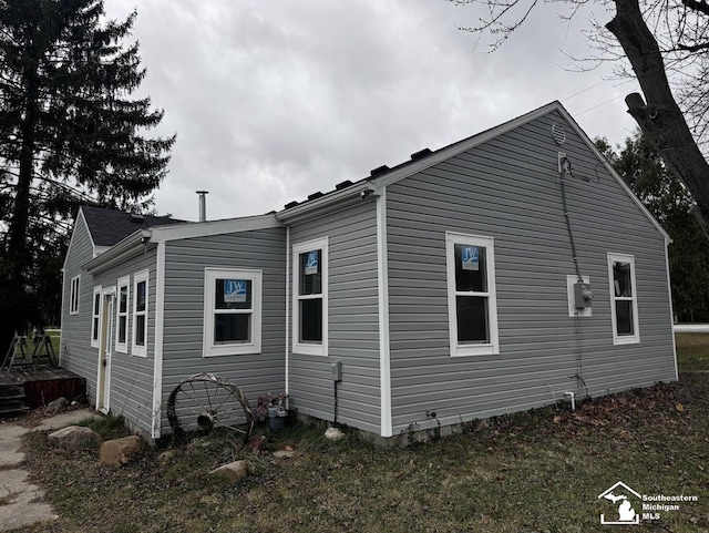 view of property exterior with a lawn