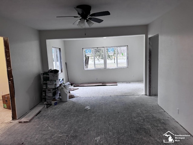 unfurnished living room featuring ceiling fan and wood-type flooring