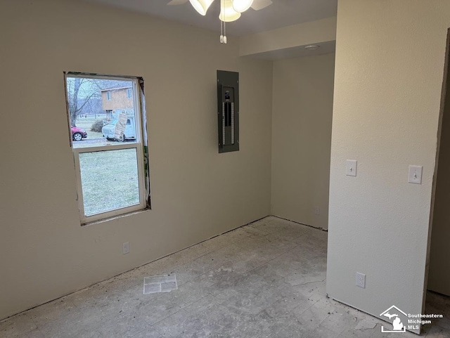 unfurnished room featuring plenty of natural light, ceiling fan, and electric panel