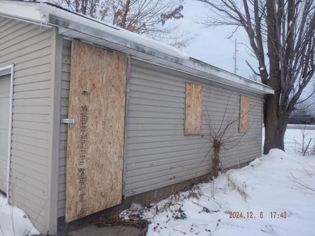 view of snowy exterior with a garage