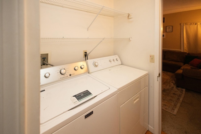 clothes washing area featuring carpet floors and washer and dryer