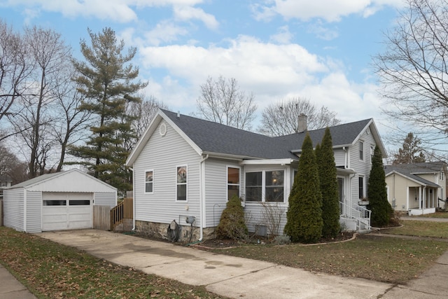 view of side of property with a yard, an outdoor structure, and a garage