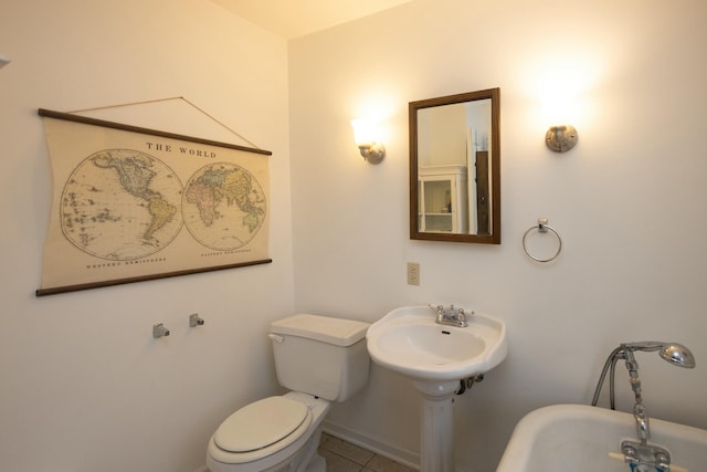 bathroom with tile patterned floors and toilet