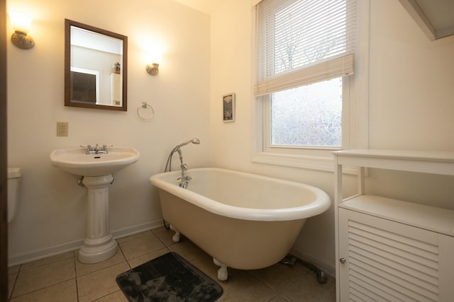 bathroom with a bathtub and tile patterned flooring