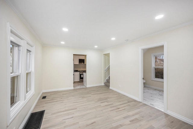 interior space with light wood-type flooring and crown molding