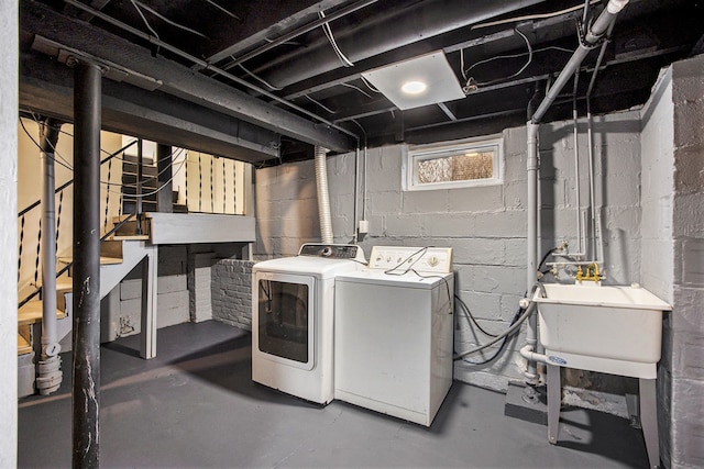 laundry area featuring washing machine and clothes dryer and sink