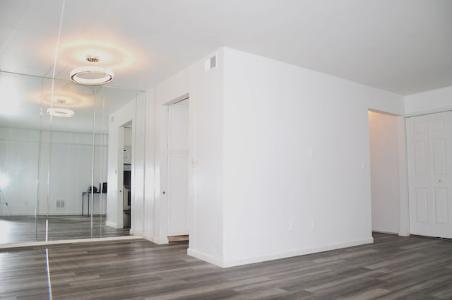 corridor featuring dark hardwood / wood-style flooring