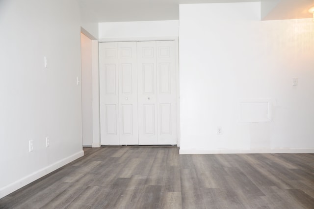 unfurnished bedroom featuring dark hardwood / wood-style floors and a closet