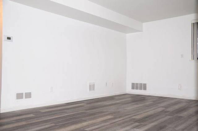 spare room featuring dark wood-type flooring