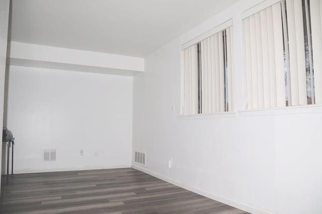 empty room with dark wood-type flooring