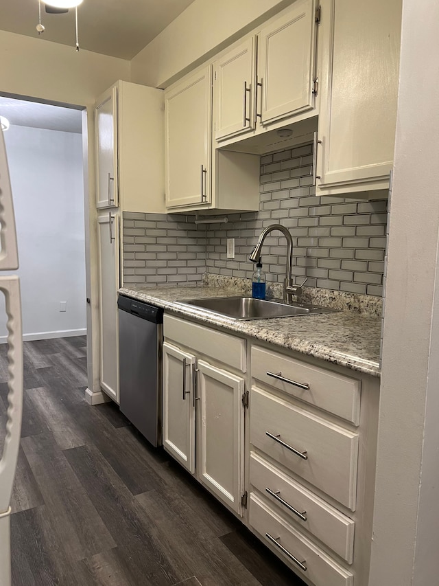 kitchen with white cabinetry, dishwasher, and sink