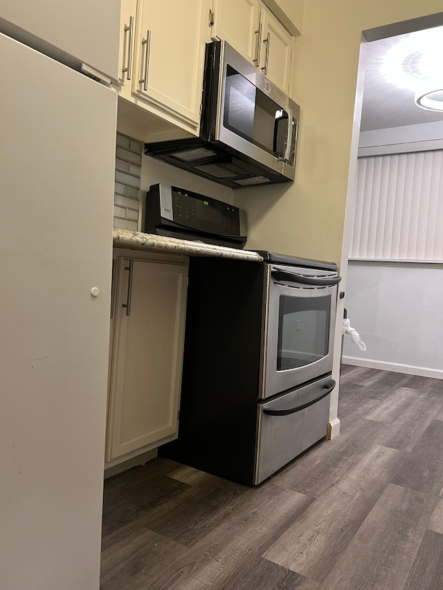 kitchen featuring stainless steel appliances, dark wood-type flooring, and white cabinets