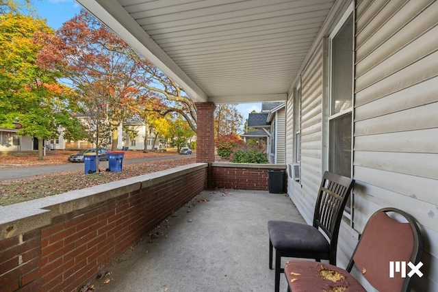 view of patio featuring cooling unit and covered porch