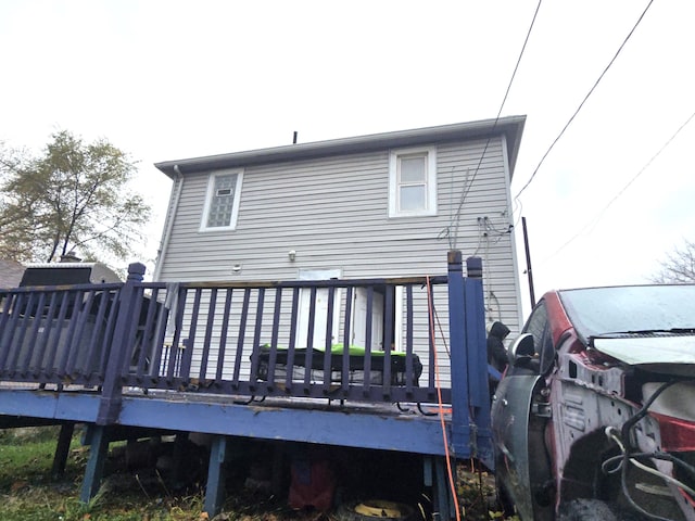 rear view of property featuring a wooden deck