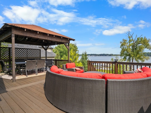 wooden terrace featuring a gazebo, an outdoor hangout area, and a water view