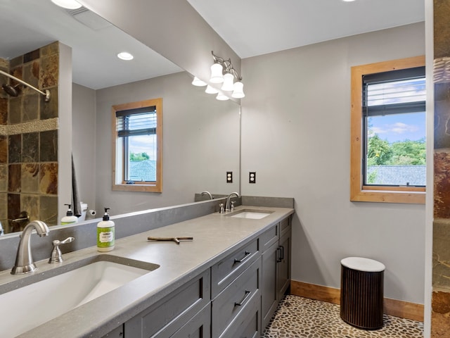 bathroom with tile patterned flooring, vanity, and a wealth of natural light