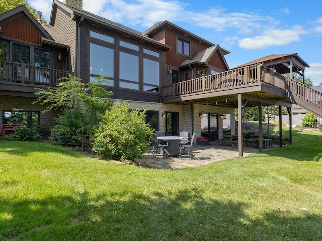 rear view of house with a yard, a patio, and a deck