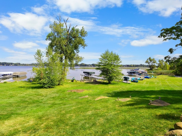 view of yard featuring a boat dock and a water view