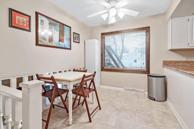 dining space featuring light tile patterned floors and ceiling fan