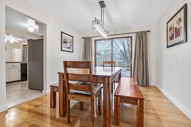 dining area featuring light hardwood / wood-style floors and ceiling fan