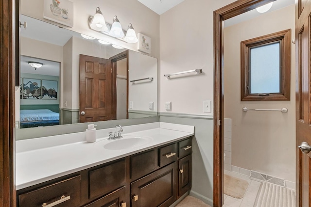 bathroom featuring tile patterned flooring and vanity