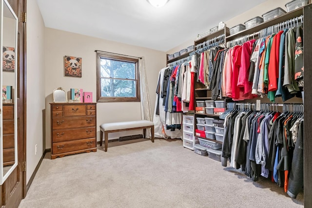 walk in closet with carpet