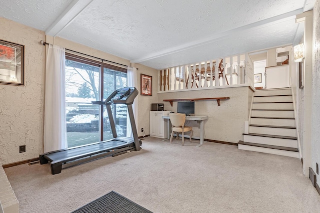 workout area with a textured ceiling and carpet floors