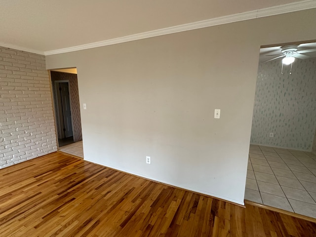 empty room with light hardwood / wood-style flooring and ornamental molding