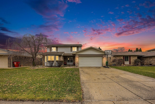 view of front of home with a garage and a yard