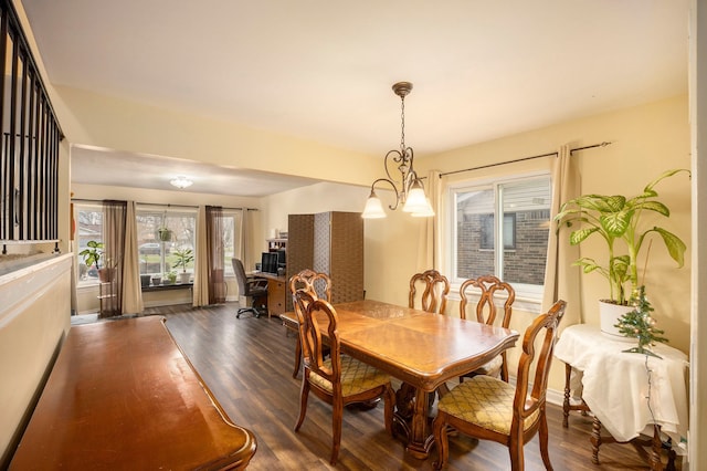 dining room featuring plenty of natural light, dark hardwood / wood-style floors, and a chandelier