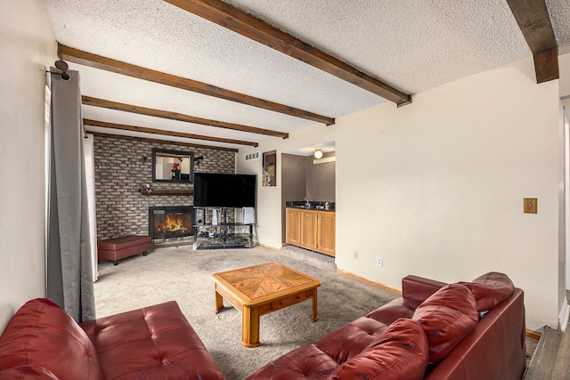 living room featuring a fireplace, beam ceiling, carpet floors, and a textured ceiling