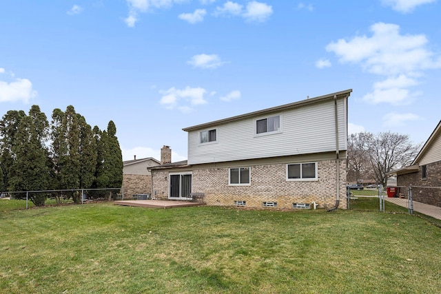 rear view of house featuring a lawn and a patio area