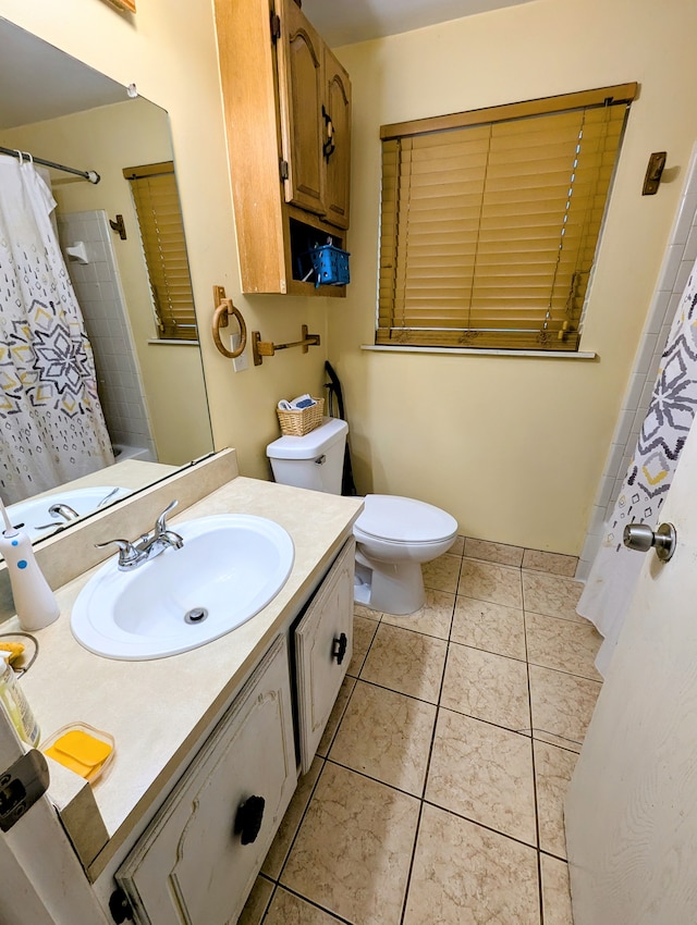 bathroom featuring tile patterned flooring, vanity, and toilet