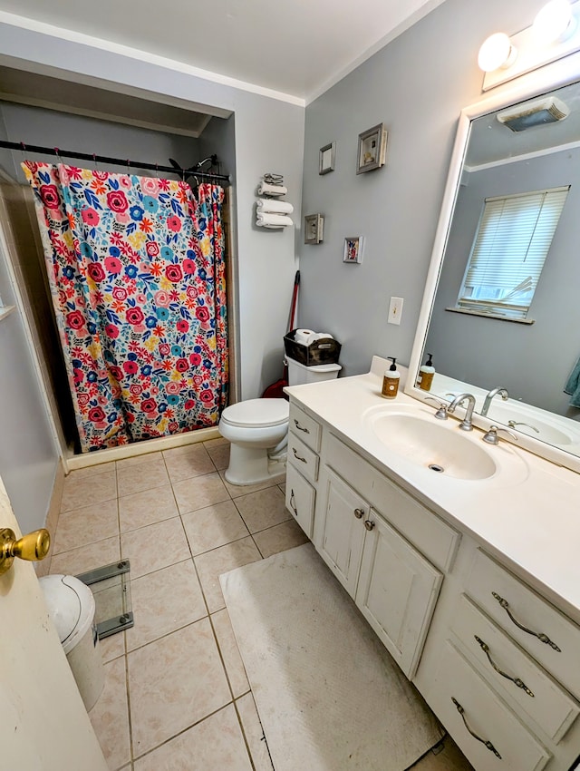 bathroom with tile patterned flooring, vanity, toilet, and ornamental molding