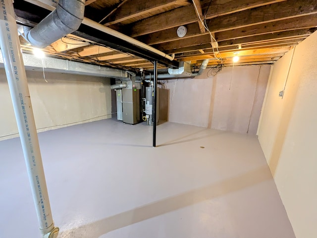 basement featuring gas water heater and heating unit