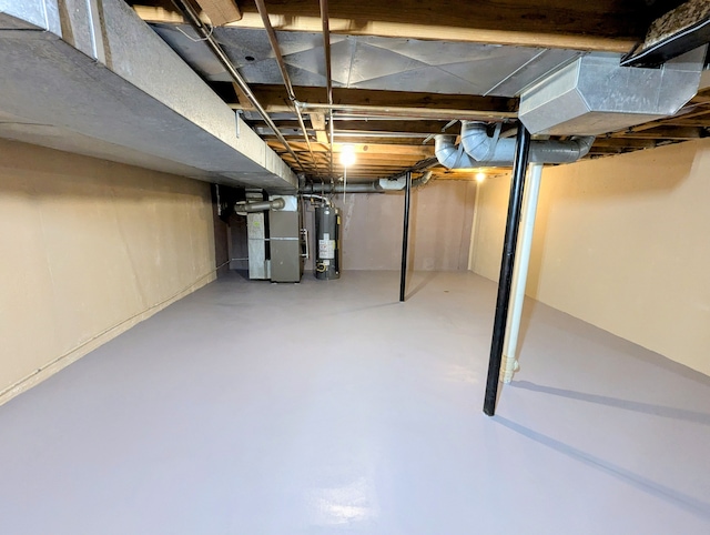 basement featuring gas water heater and heating unit