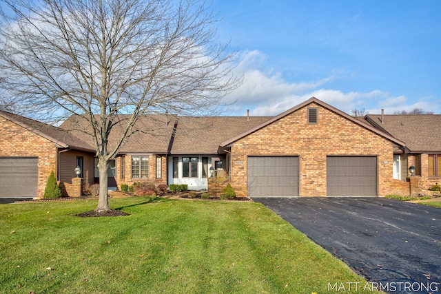 ranch-style house featuring a garage and a front yard