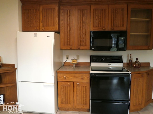 kitchen featuring electric range and white fridge