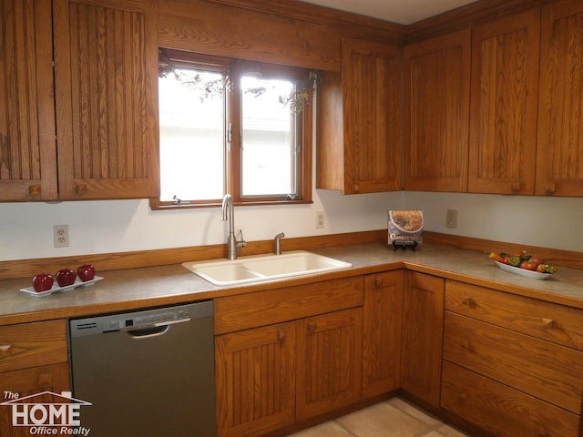 kitchen featuring dishwasher, light tile patterned floors, and sink