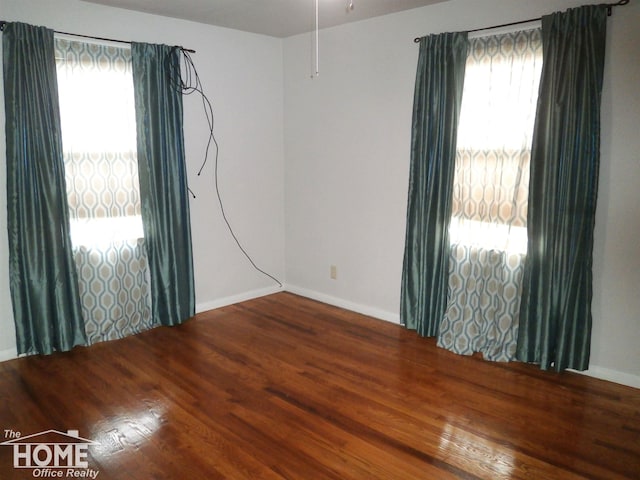 spare room featuring wood-type flooring and a wealth of natural light