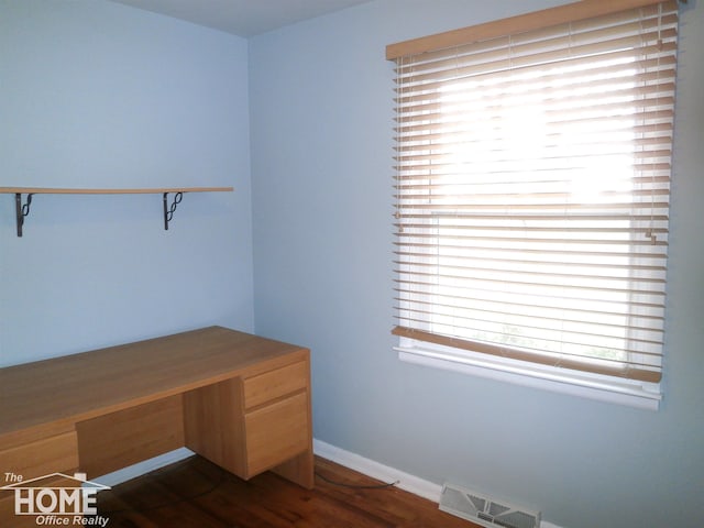 unfurnished office featuring dark hardwood / wood-style flooring