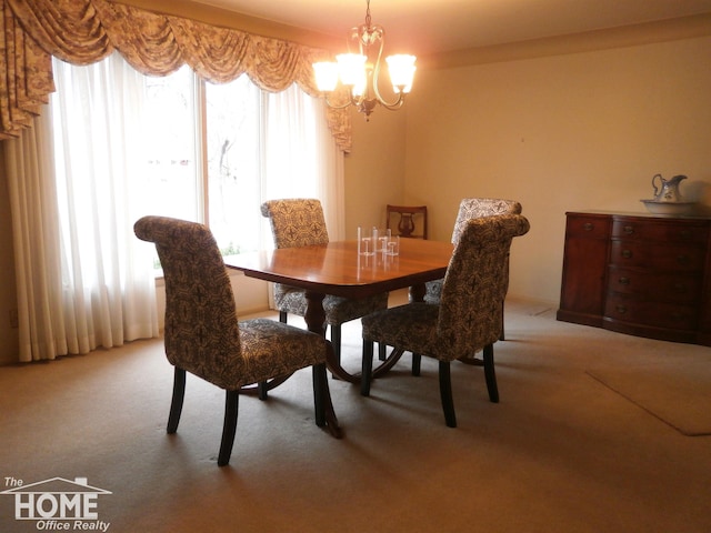 dining area with light colored carpet, a wealth of natural light, and an inviting chandelier