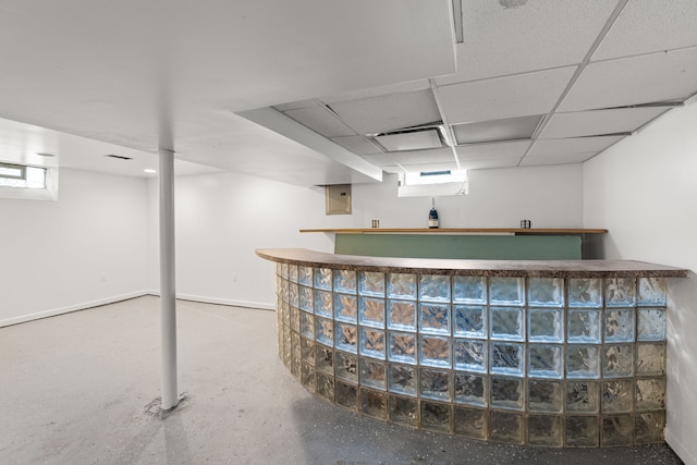 basement featuring a paneled ceiling