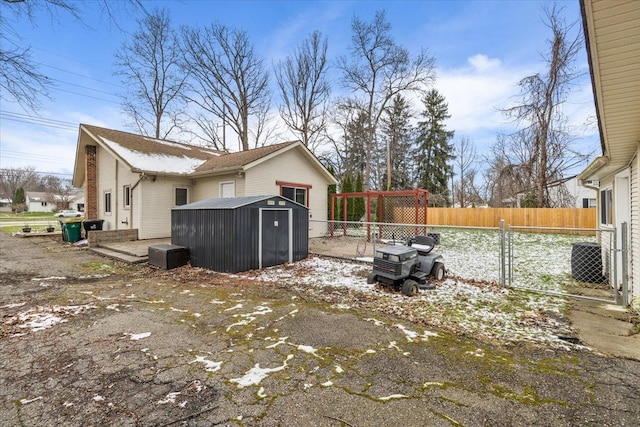 view of side of home with a storage shed